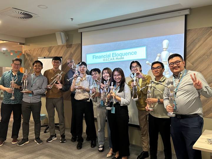 A workshop group holding their OSCAR figurines
