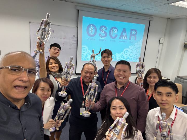 A workshop group holding their OSCAR figurines