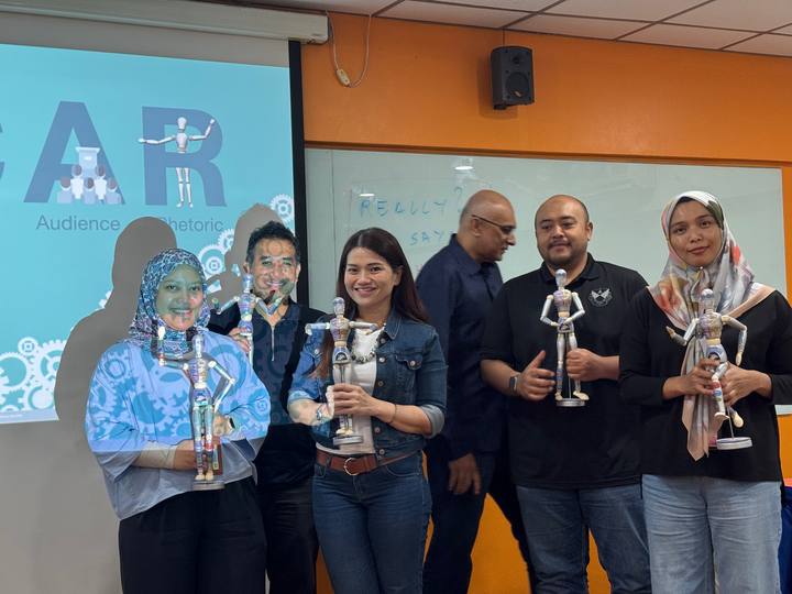A workshop group holding their OSCAR figurines