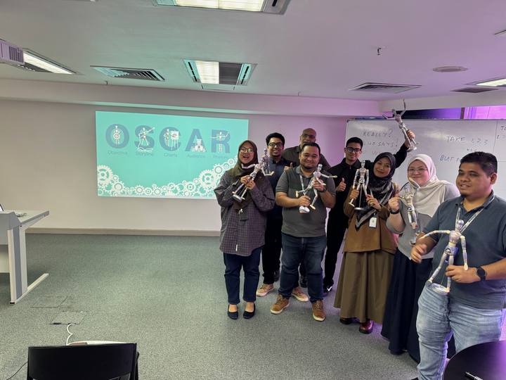 A workshop group holding their OSCAR figurines