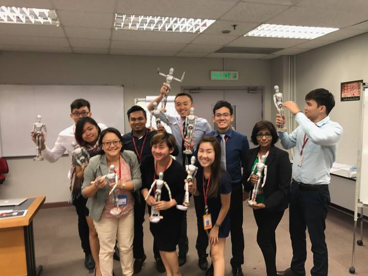 A workshop group holding their OSCAR figurines