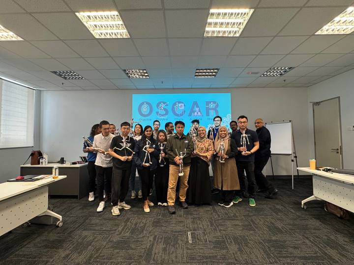 A workshop group holding their OSCAR figurines