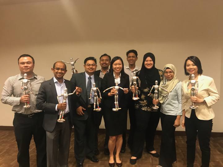 A workshop group holding their OSCAR figurines