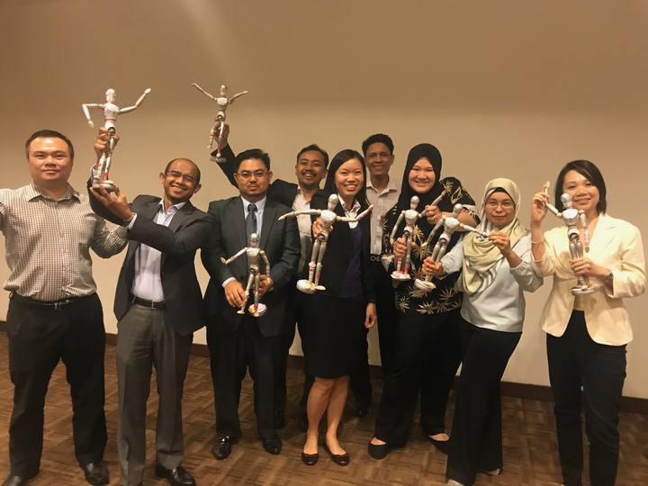 A workshop group holding their OSCAR figurines