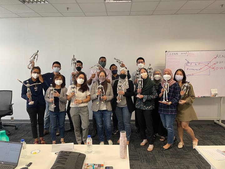 A workshop group holding their OSCAR figurines