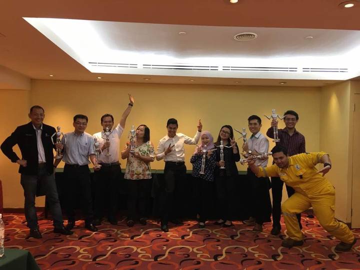 A workshop group holding their OSCAR figurines