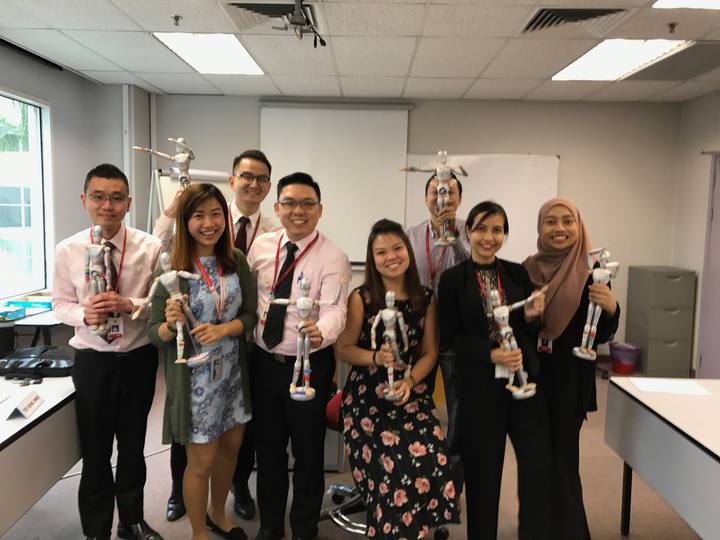 A workshop group holding their OSCAR figurines