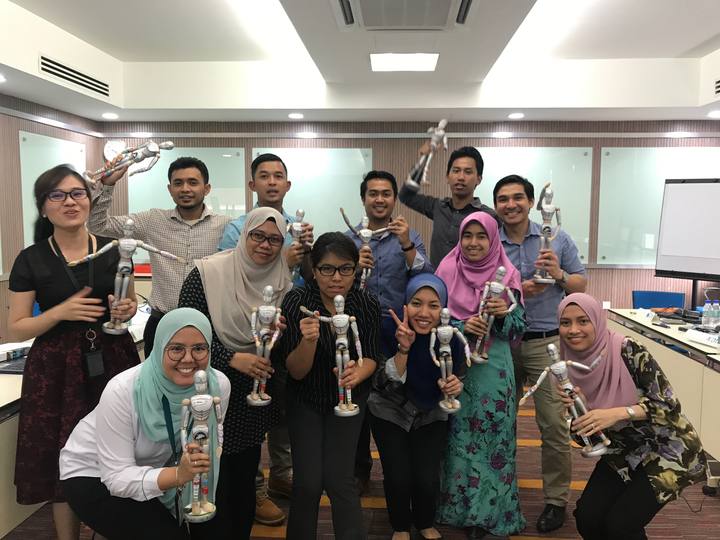 A workshop group holding their OSCAR figurines