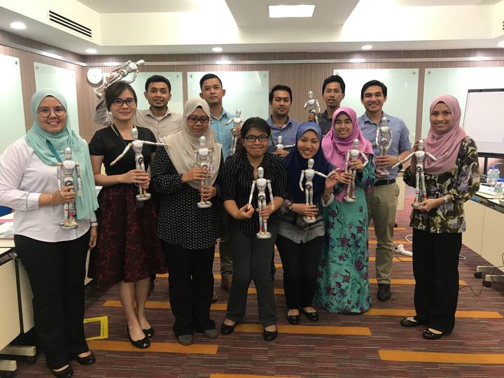 A workshop group holding their OSCAR figurines