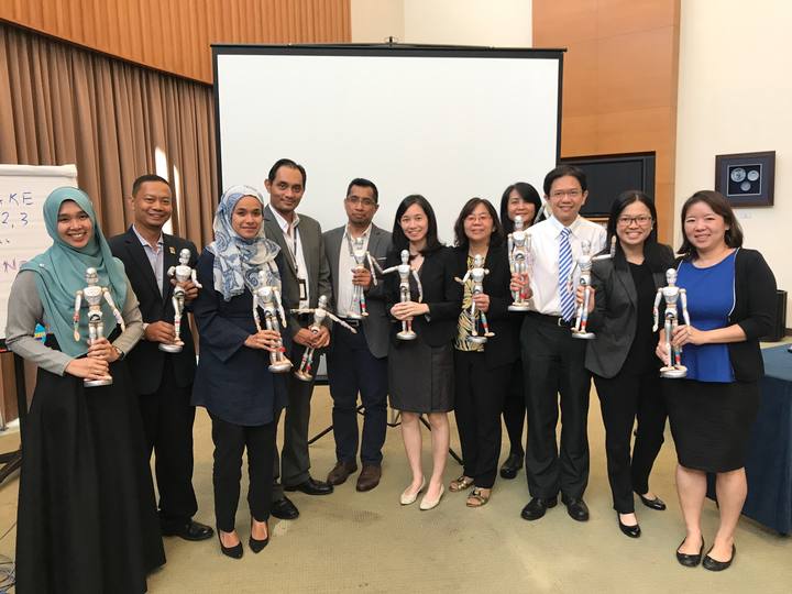 A workshop group holding their OSCAR figurines