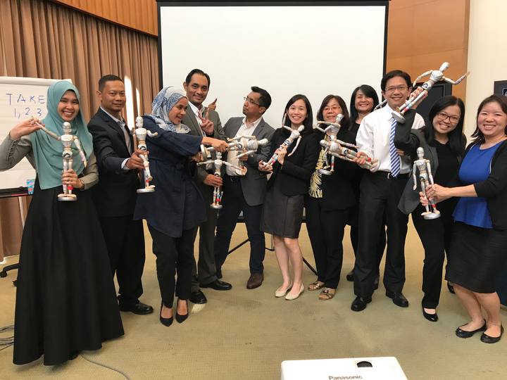 A workshop group holding their OSCAR figurines