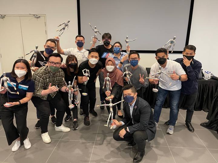 A workshop group holding their OSCAR figurines