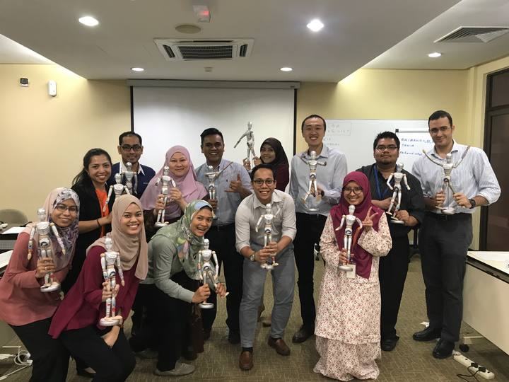 A workshop group holding their OSCAR figurines