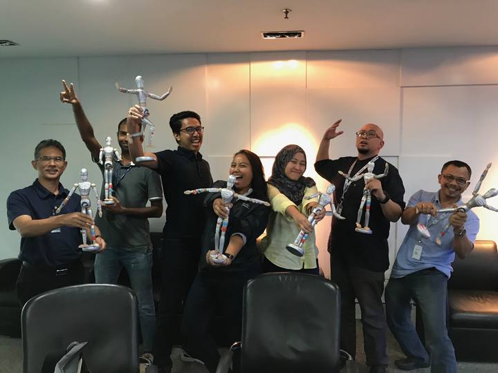 A workshop group holding their OSCAR figurines