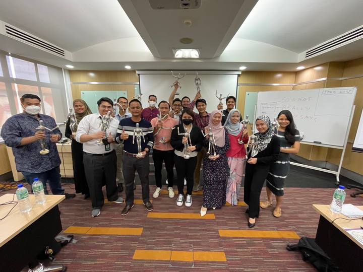 A workshop group holding their OSCAR figurines