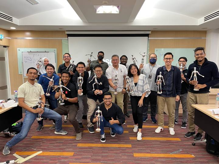 A workshop group holding their OSCAR figurines