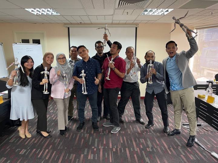 A workshop group holding their OSCAR figurines